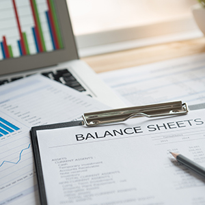 balance sheets and other papers on laptop boynton beach fl